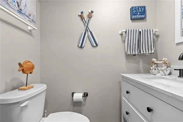 a bathroom with a sink a light fixture and a toilet