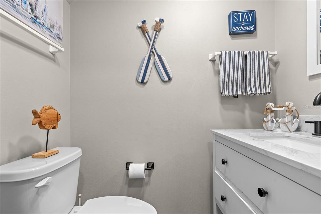 1752 Stickney Point Road, Unit 102 Sarasota, FL 34231 - Photo 9 of 50 a bathroom with a sink a light fixture and a toilet