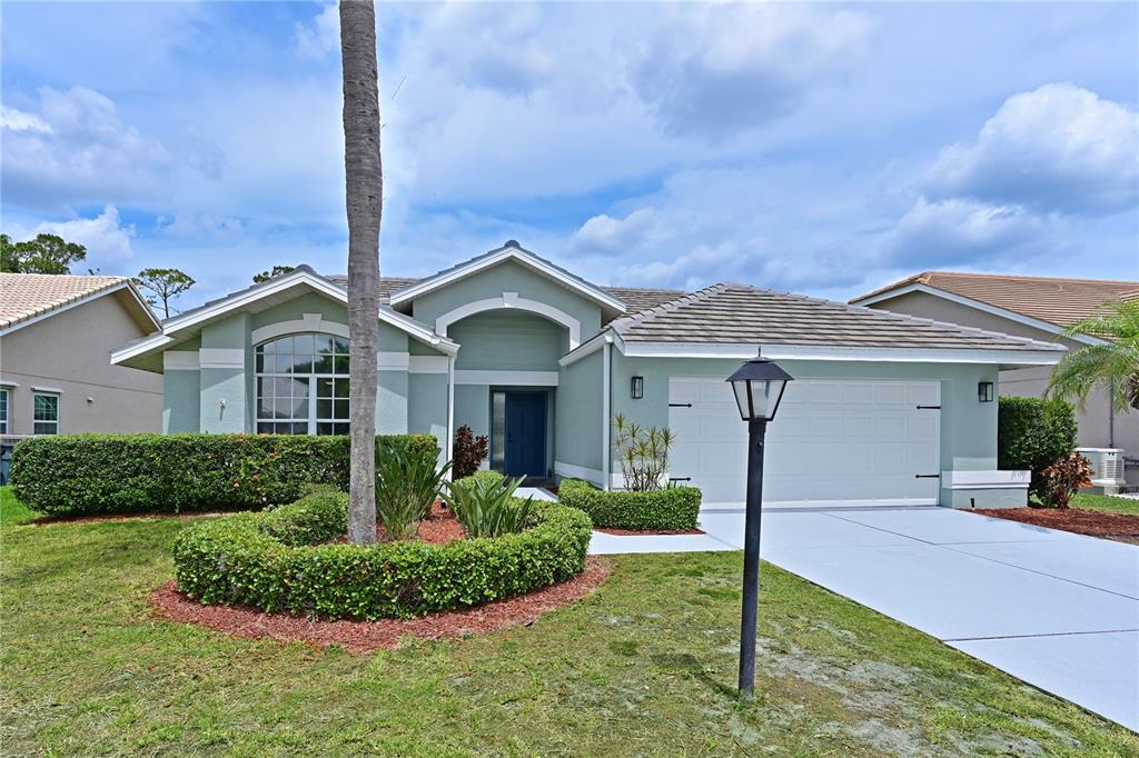 6427 Stone River Road Bradenton, FL 34203 - Photo 1 of 1 a front view of a house with a yard and garage