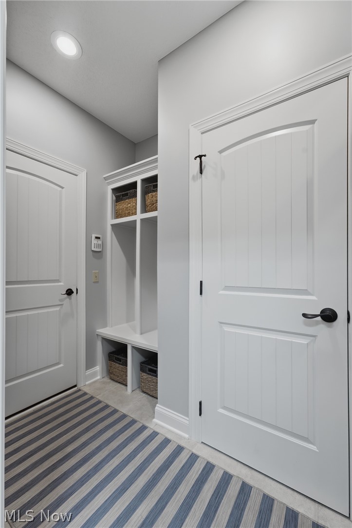 3955 Spring Brook Way Wooster, OH 44691 - Photo 22 of 50 Built-in mudroom storage with integrated bench seating, recessed lighting, and white paneled doors with bronze hardware