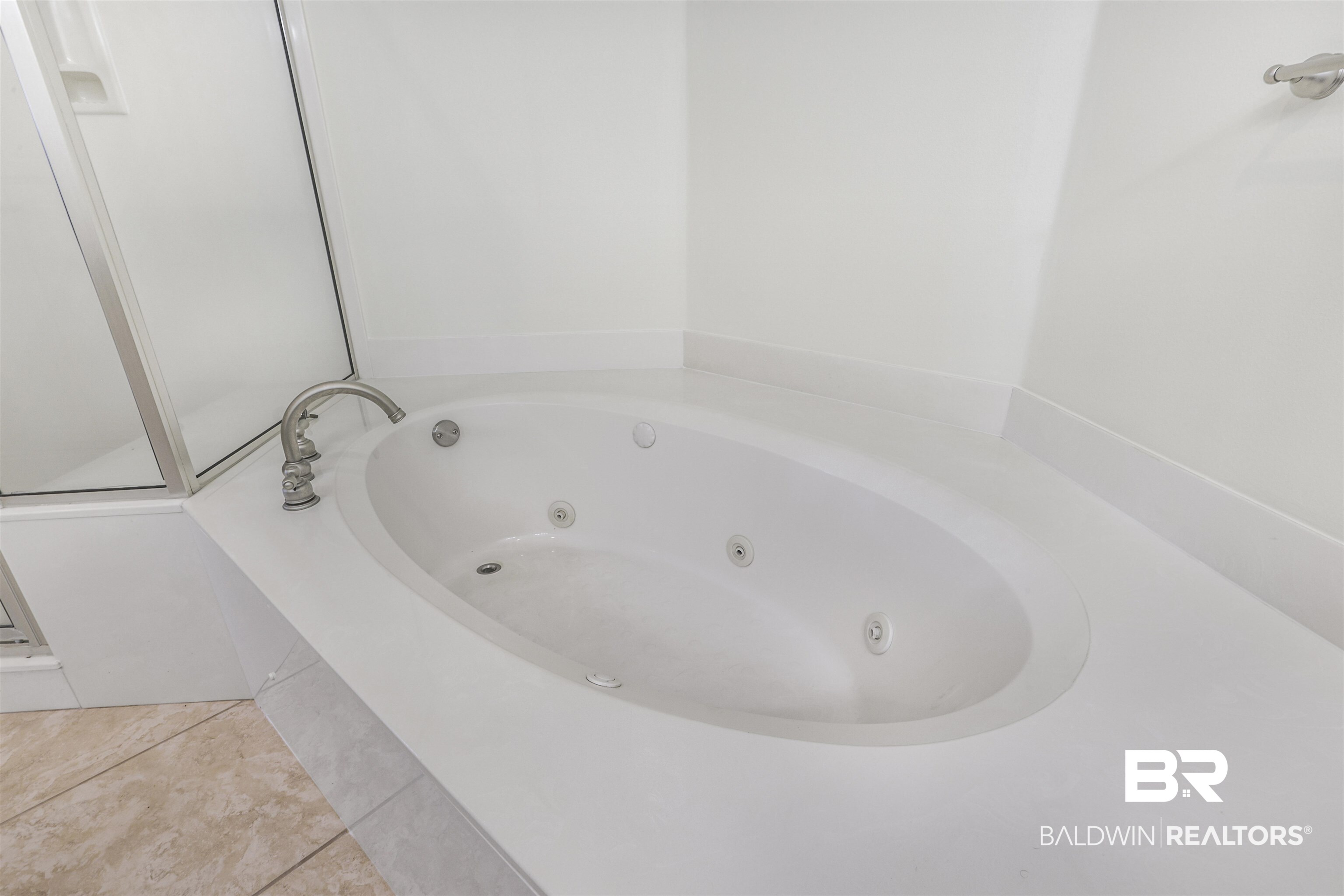 28250 Canal Road, Unit 106 Orange Beach, AL 36561 - Photo 16 of 50 Bathroom with a tub with jets and tile patterned flooring