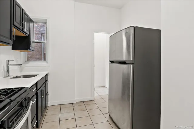 a kitchen with stainless steel appliances a refrigerator and a sink