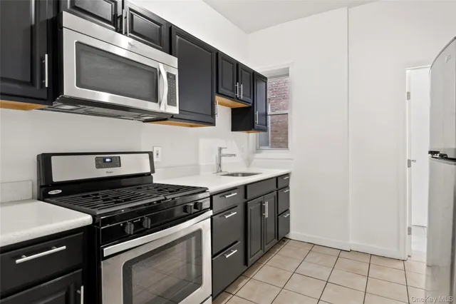 a kitchen with stainless steel appliances a stove a microwave and cabinets