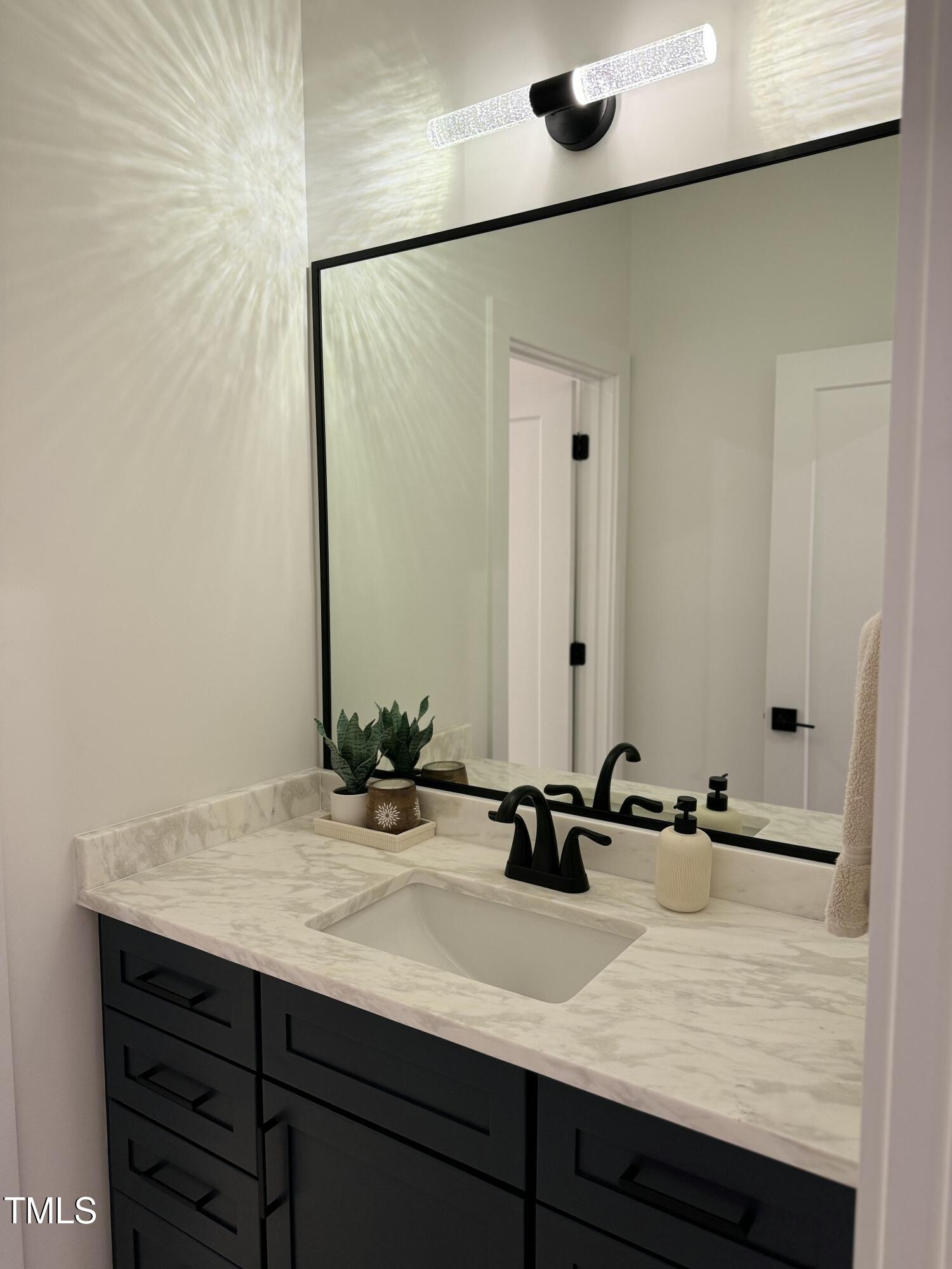 1101 South Chavis Road Kittrell, NC 27544 - Photo 12 of 20 a bathroom with a sink and a mirror