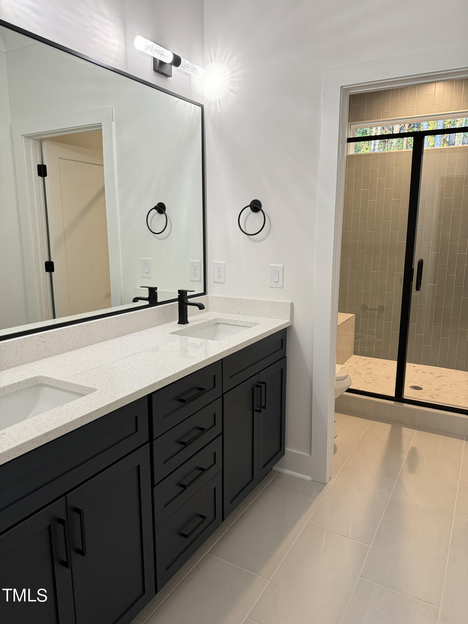 1101 South Chavis Road Kittrell, NC 27544 - Photo 17 of 20 a spacious bathroom with a double vanity sink a mirror and shower
