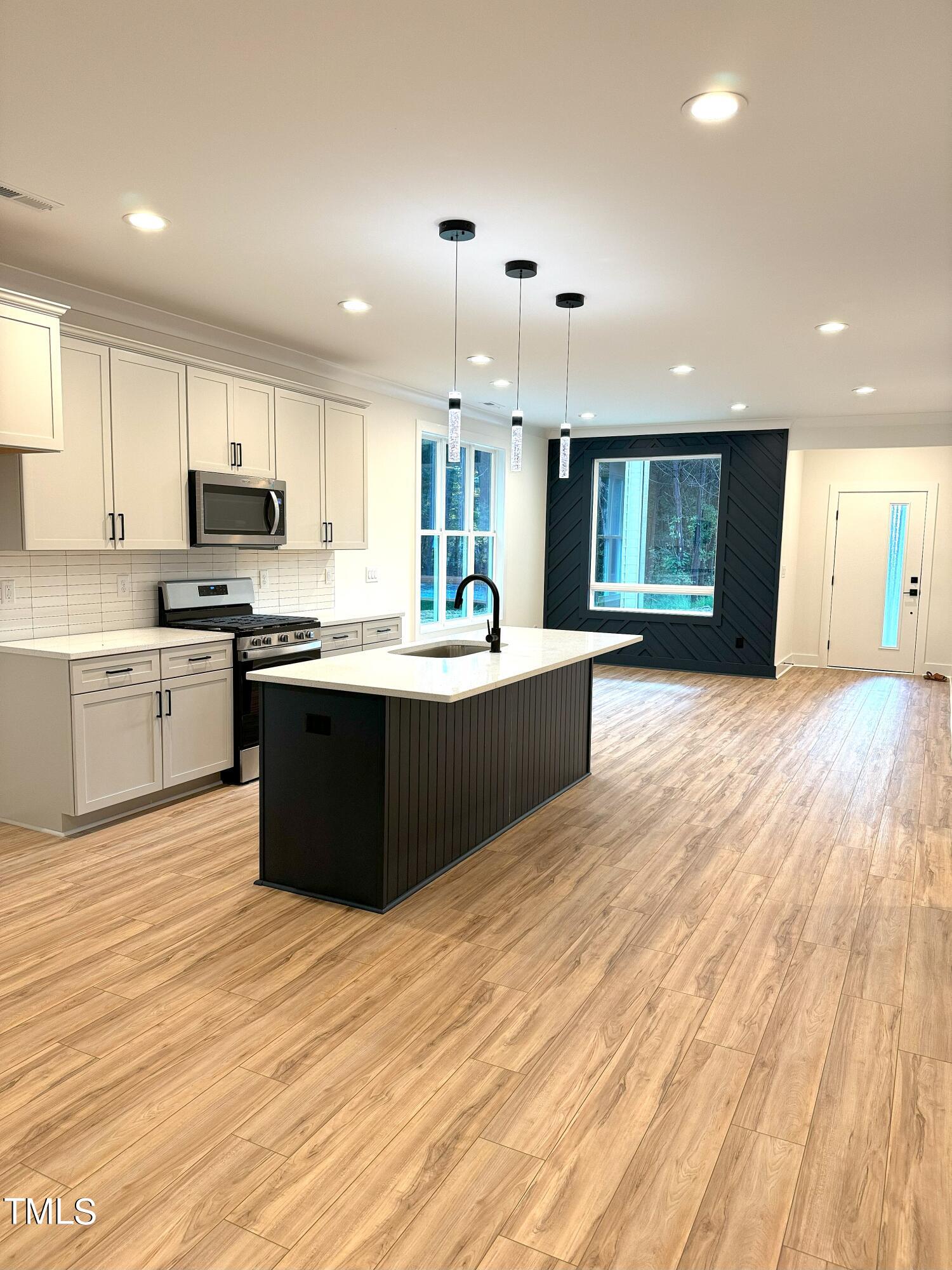 1101 South Chavis Road Kittrell, NC 27544 - Photo 3 of 20 a kitchen with stainless steel appliances granite countertop a sink dishwasher a stove and a refrigerator with wooden floor