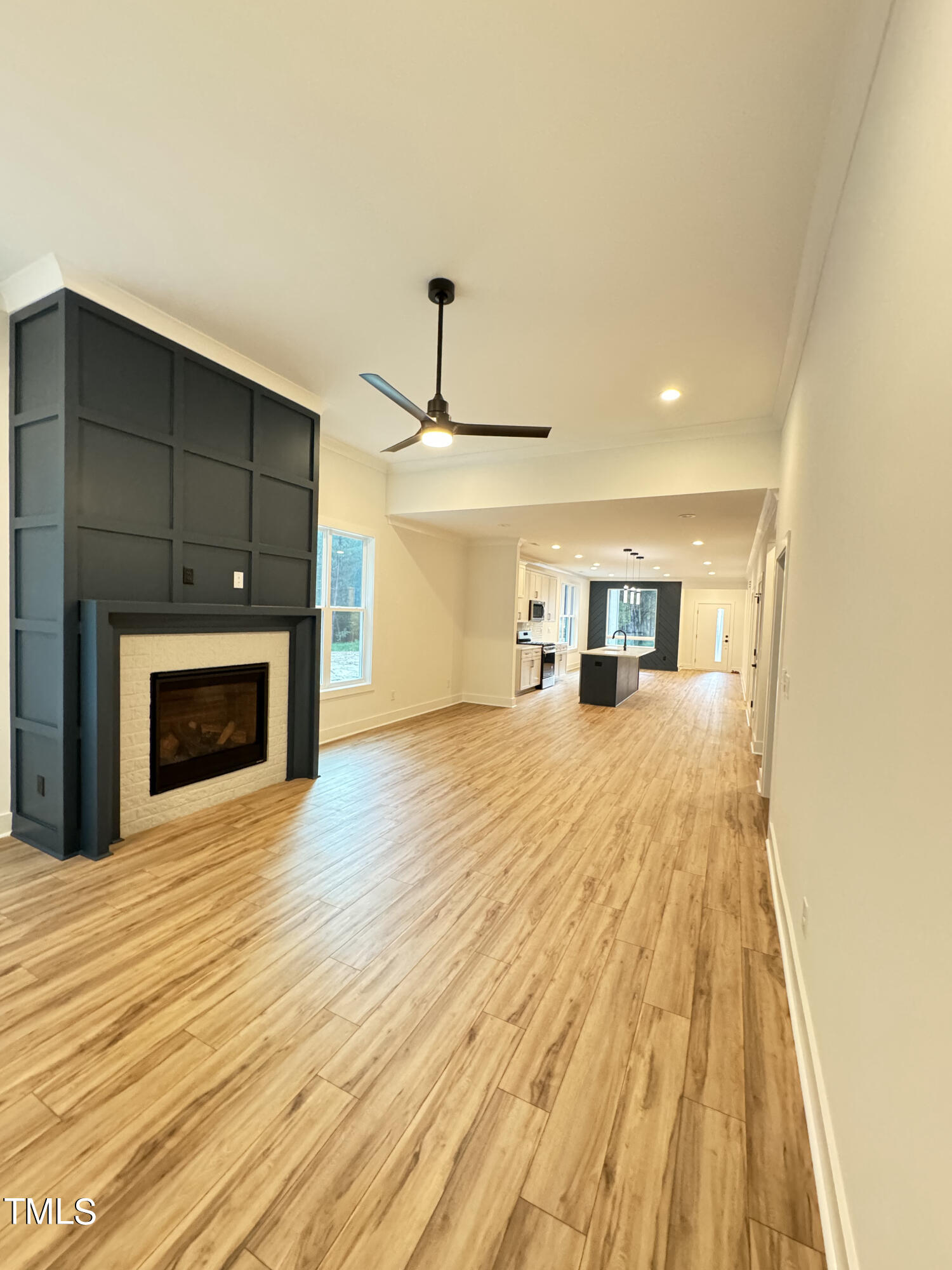 1101 South Chavis Road Kittrell, NC 27544 - Photo 4 of 20 a empty room with a fireplace and wooden floor
