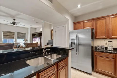 a kitchen with stainless steel appliances granite countertop a stove and a refrigerator