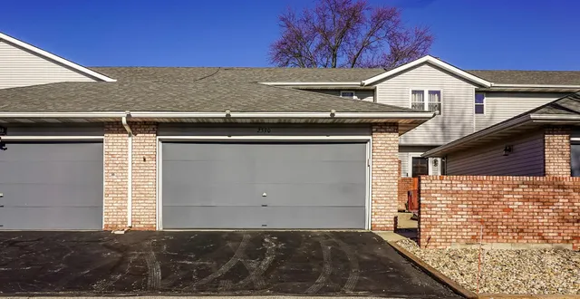 a front view of a house with a garage