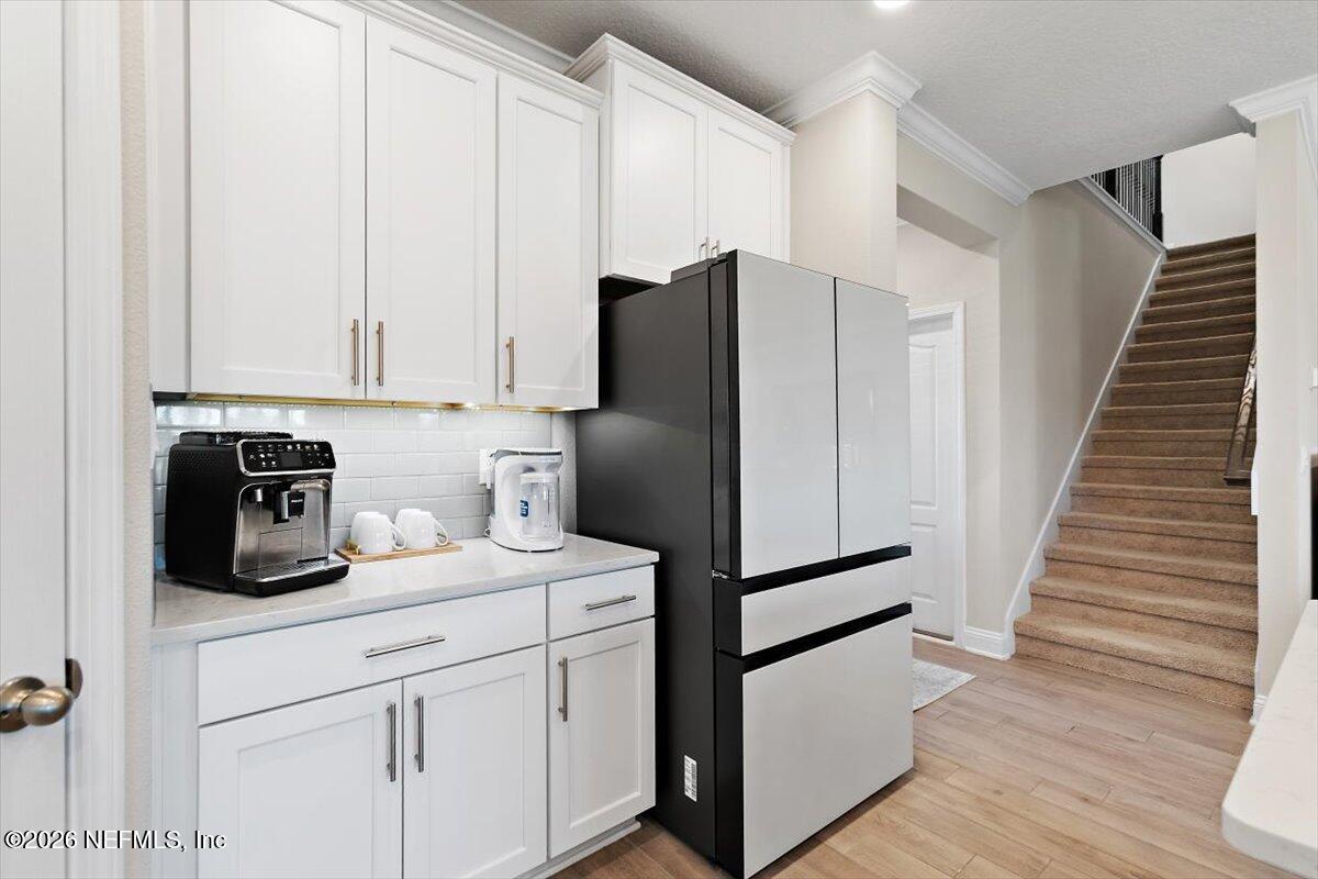 15 Zancara Street St. Augustine, FL 32084 - Photo 11 of 46 a kitchen with a refrigerator and cabinets