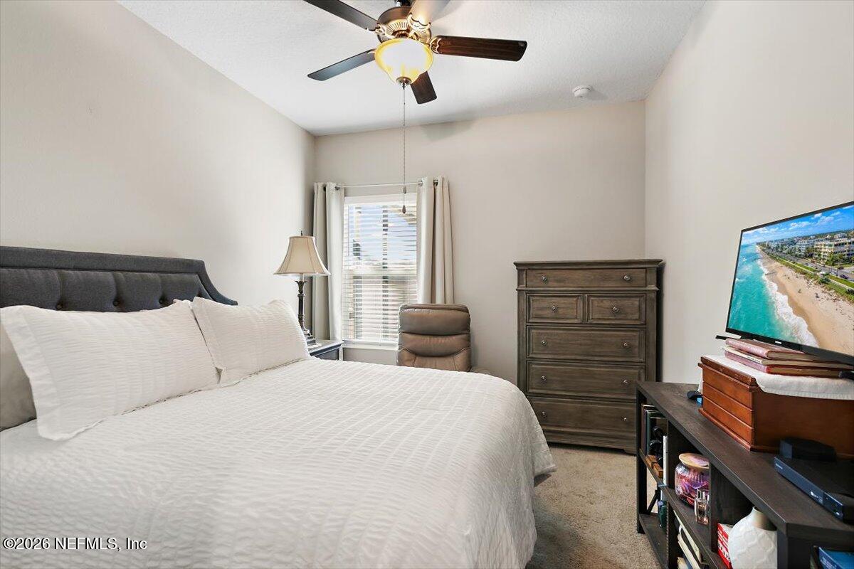 15 Zancara Street St. Augustine, FL 32084 - Photo 13 of 46 a bedroom with a bed and a chandelier