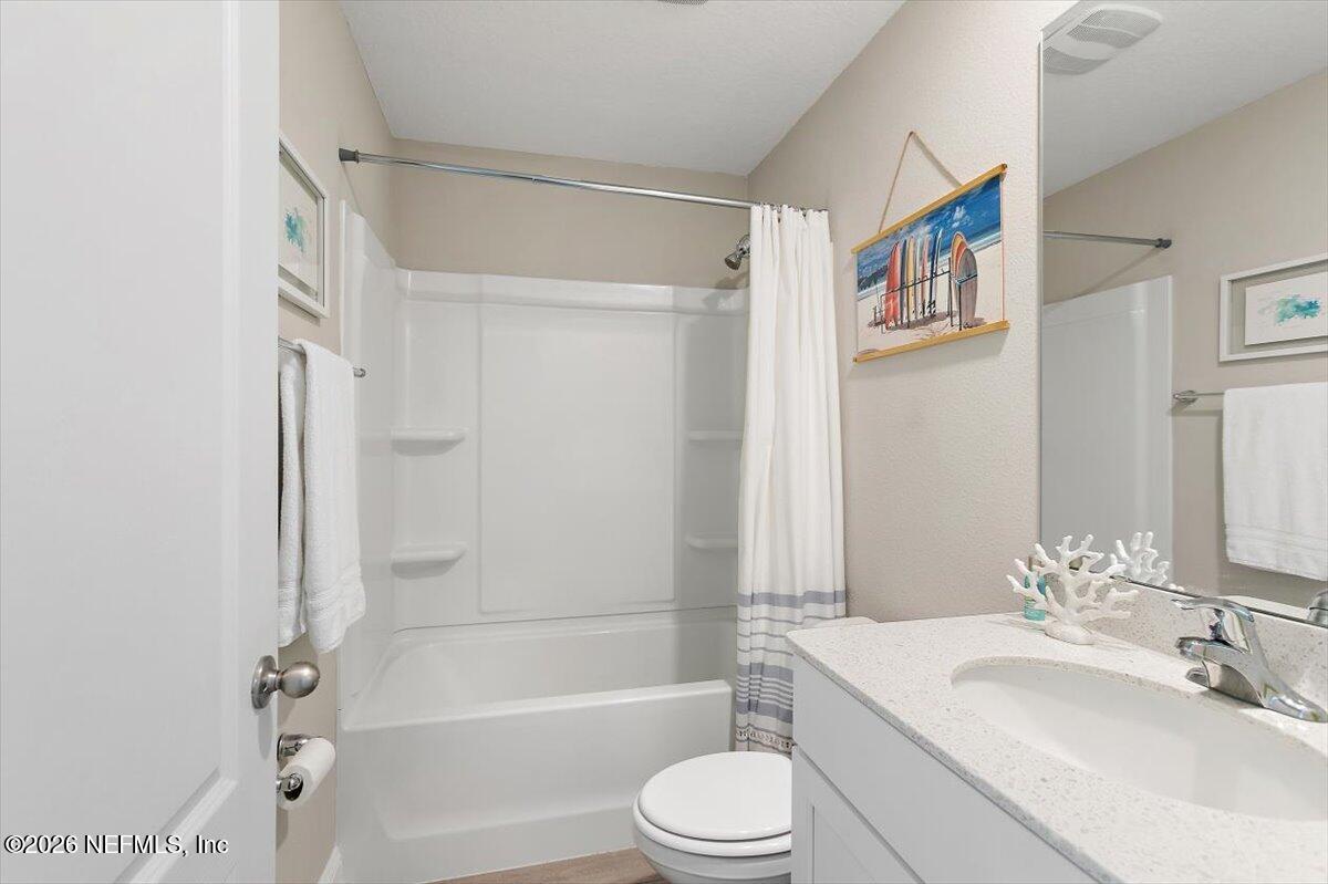 15 Zancara Street St. Augustine, FL 32084 - Photo 24 of 46 a bathroom with a bathtub shower sink vanity mirror and toilet