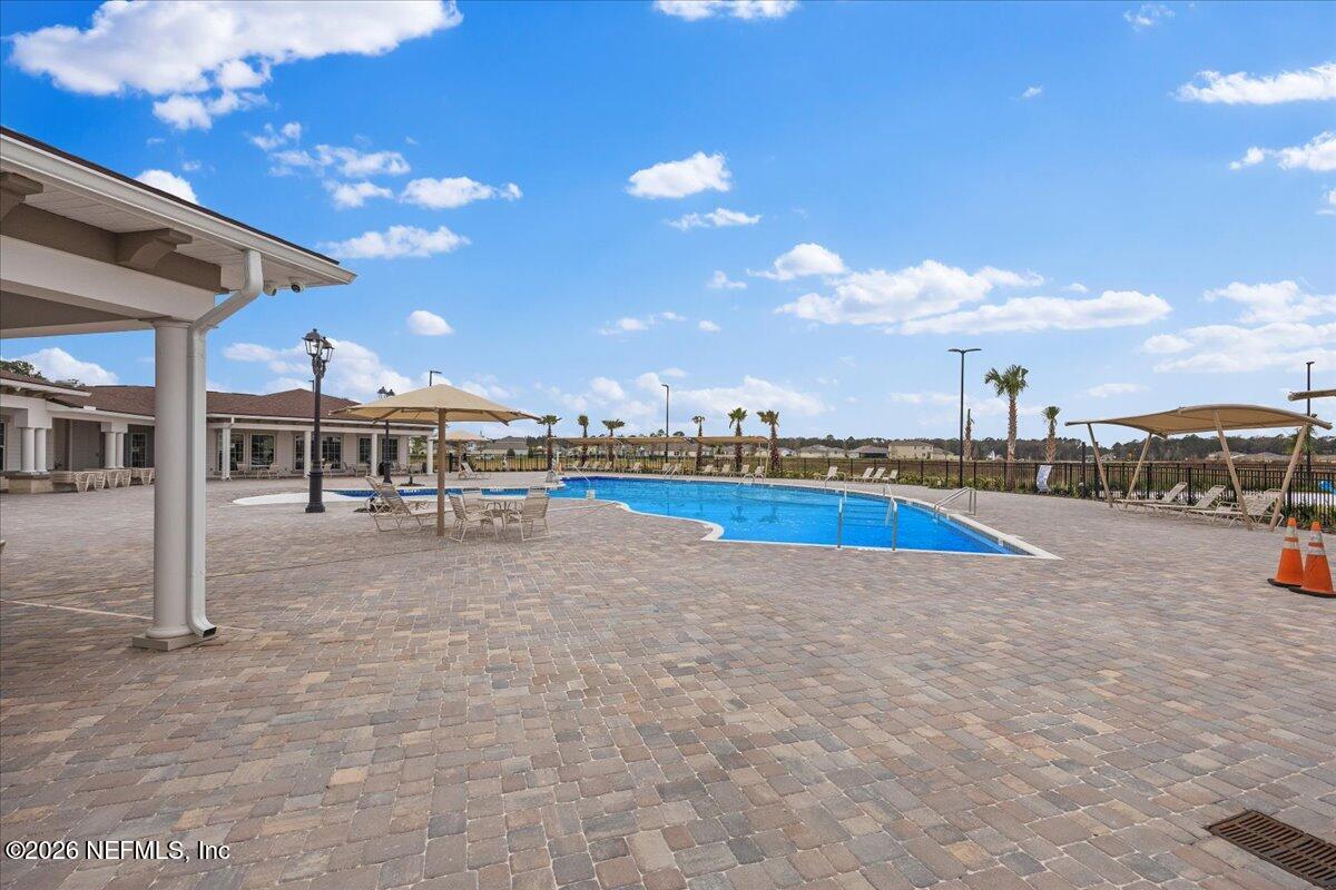 15 Zancara Street St. Augustine, FL 32084 - Photo 38 of 46 a view of a swimming pool with lawn chairs