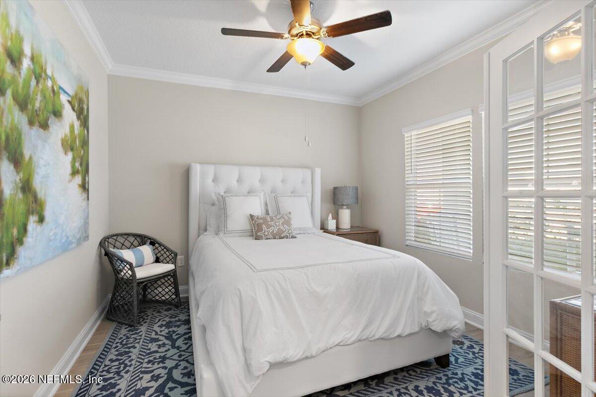 15 Zancara Street St. Augustine, FL 32084 - Photo 4 of 46 a bedroom with a bed and a chandelier