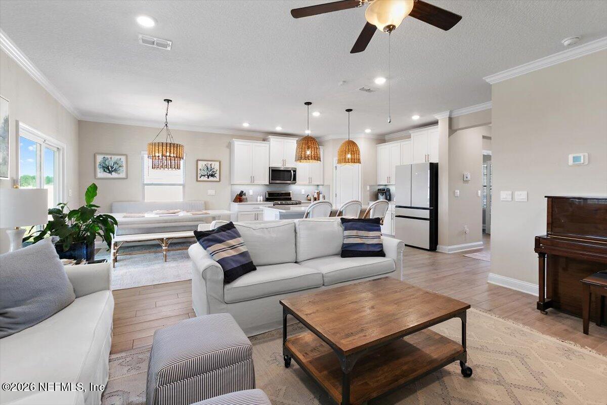 15 Zancara Street St. Augustine, FL 32084 - Photo 7 of 46 a living room with furniture and a chandelier