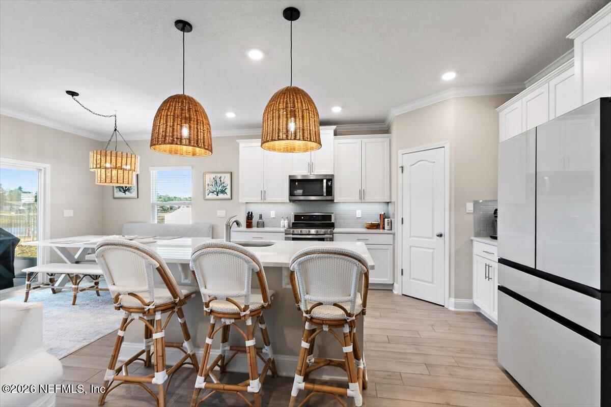 15 Zancara Street St. Augustine, FL 32084 - Photo 8 of 46 a view of a dining room with furniture window and wooden floor