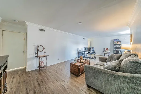 a living room with furniture and wooden floor