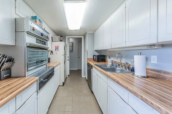 a kitchen with stainless steel appliances a sink and cabinets