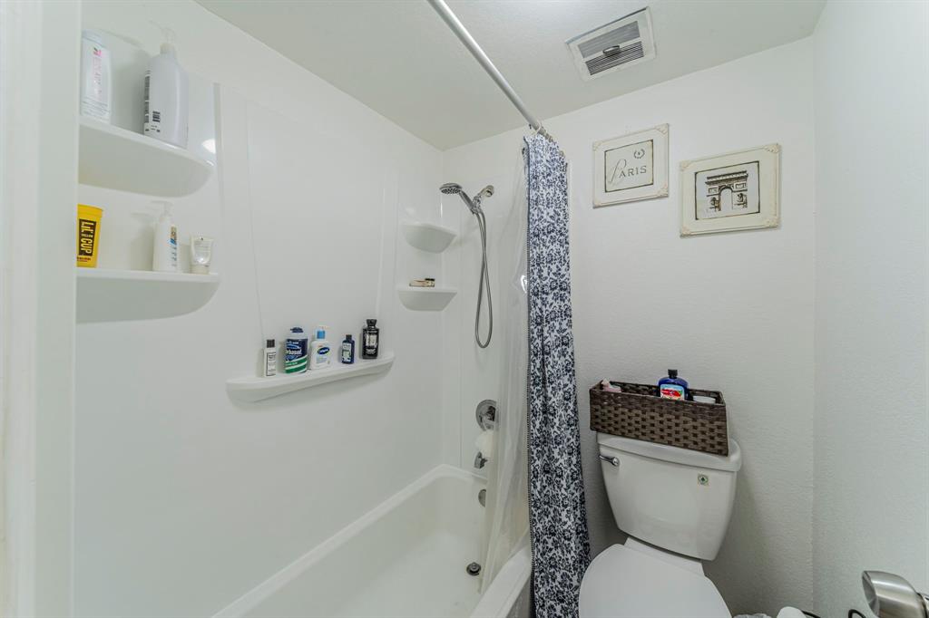 558 E Avenue, Unit B Grand Prairie, TX 75050 - Photo 9 of 16 a white toilet sitting next to a bath tub