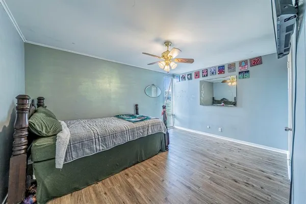 a bedroom with a bed and a chandelier