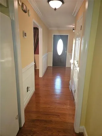 a view of a hallway with wooden floor