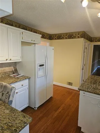 a kitchen with a refrigerator and a stove