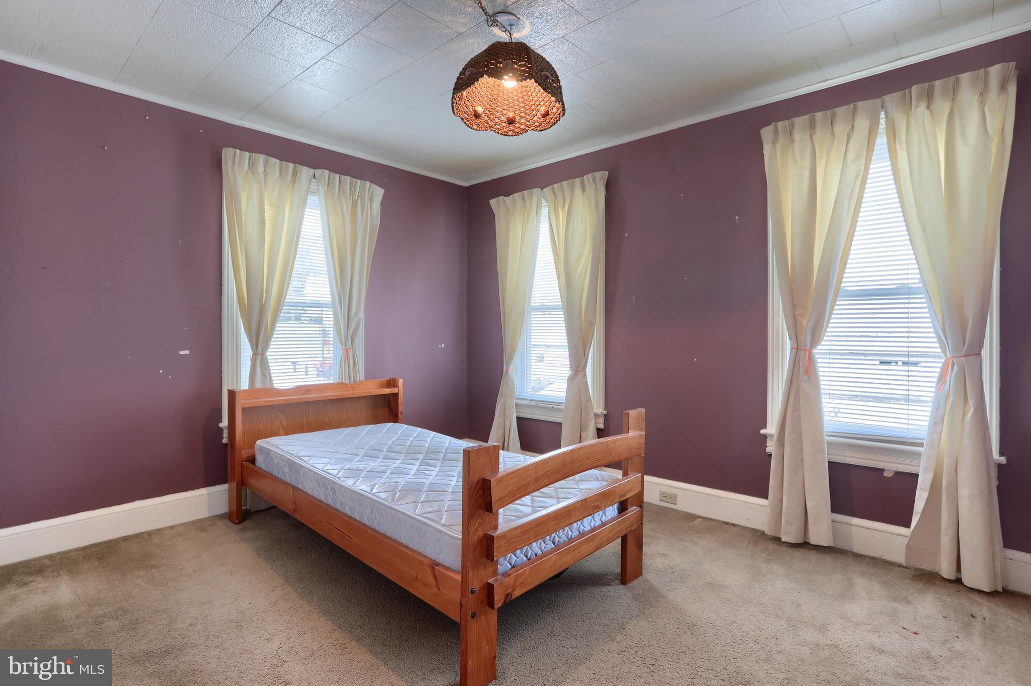 13 Montello Road Reading, PA 19608 - Photo 23 of 54 a bed sitting in a bedroom next to a window and a chandelier