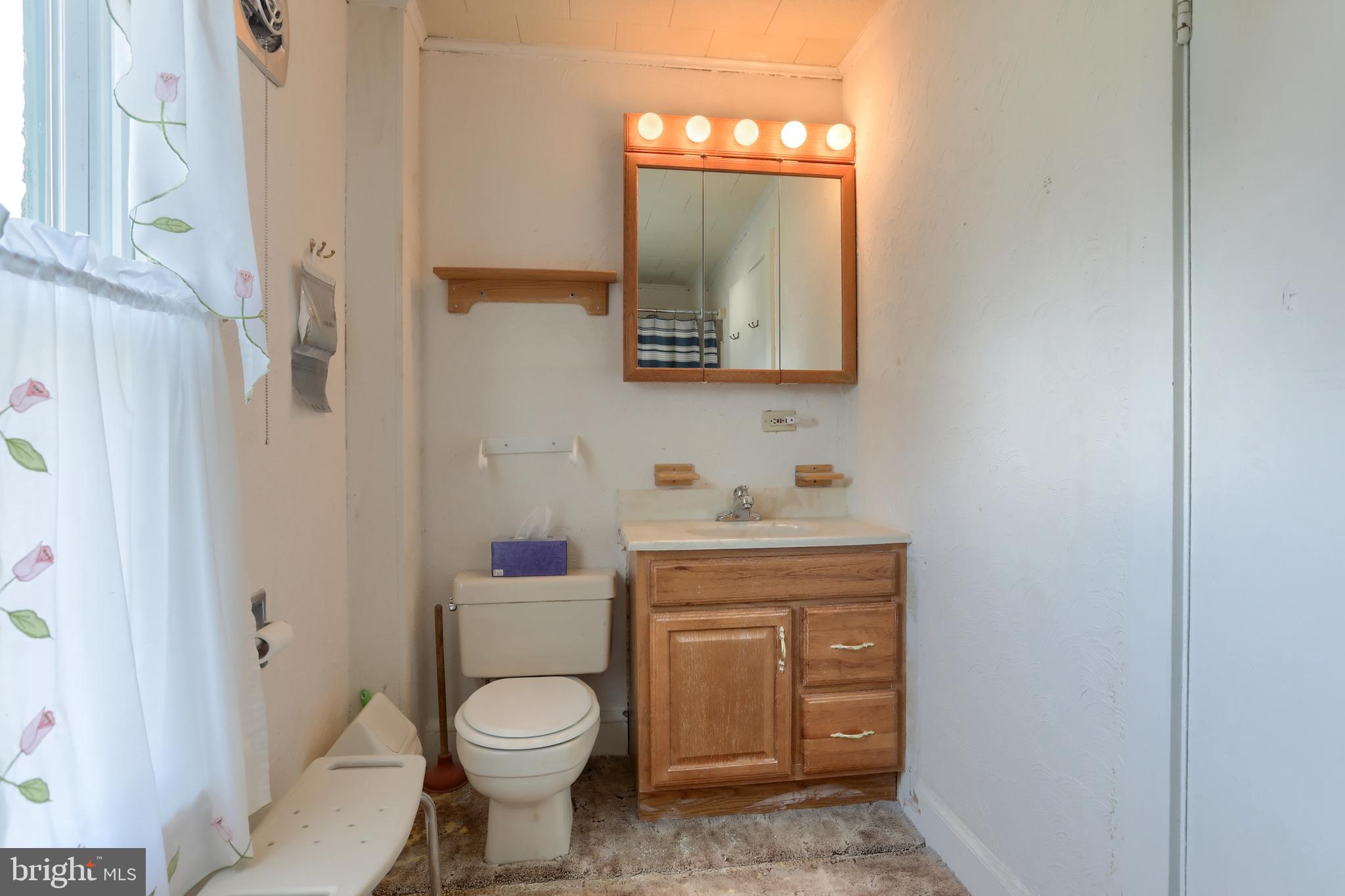13 Montello Road Reading, PA 19608 - Photo 30 of 54 a bathroom with a toilet sink vanity and mirror