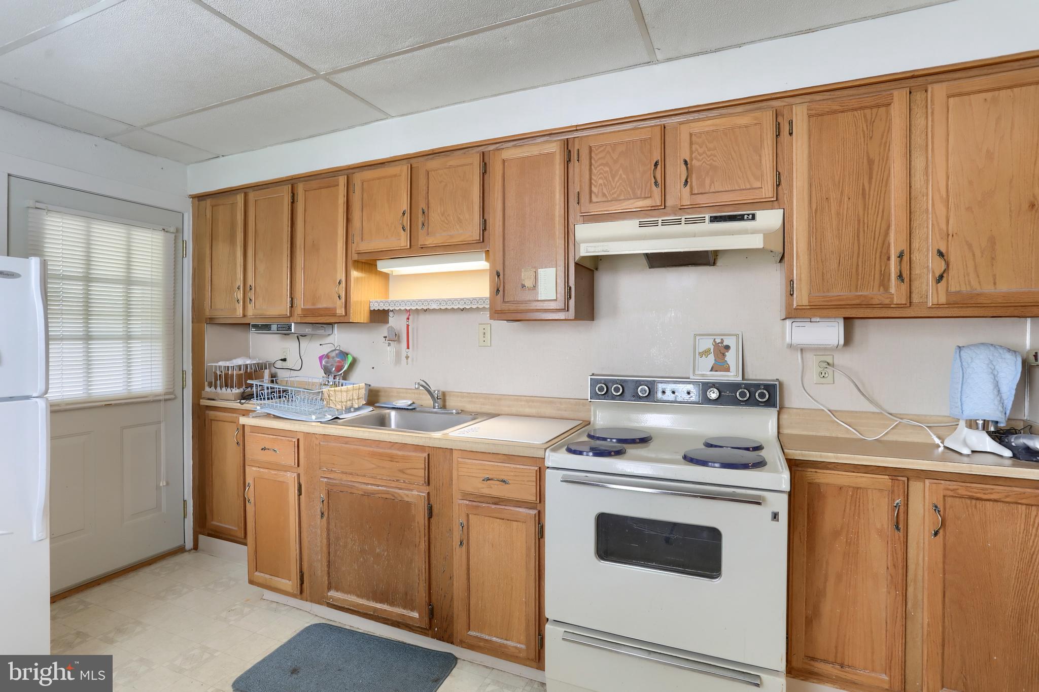 13 Montello Road Reading, PA 19608 - Photo 8 of 54 a kitchen with stainless steel appliances granite countertop a stove a sink dishwasher and a refrigerator with wooden cabinets