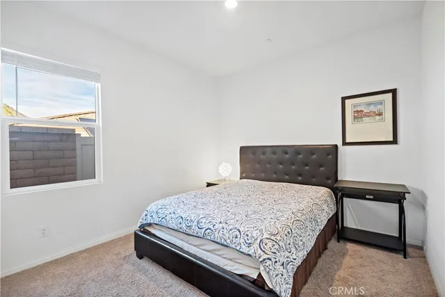 a living room with furniture and a dresser