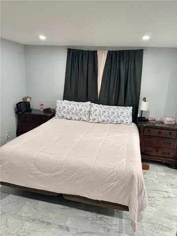 a bedroom with a bed and a dresser