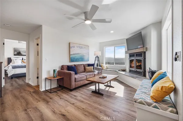 a living room with fireplace furniture and a wooden floor