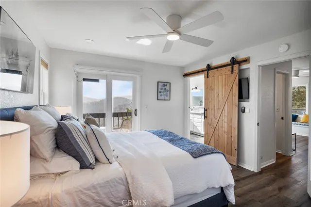 a bedroom with a bed and a large mirror