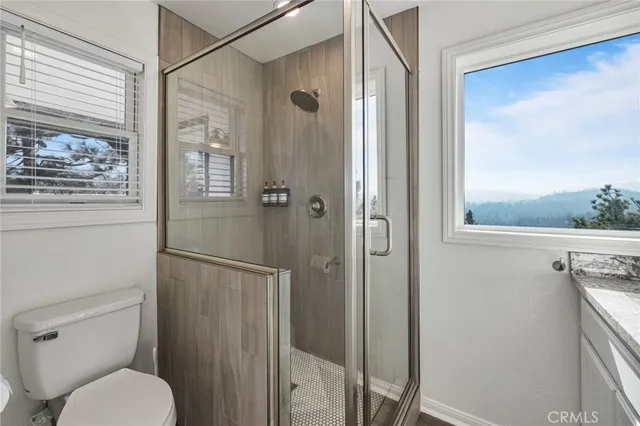 a bathroom with a toilet and a shower
