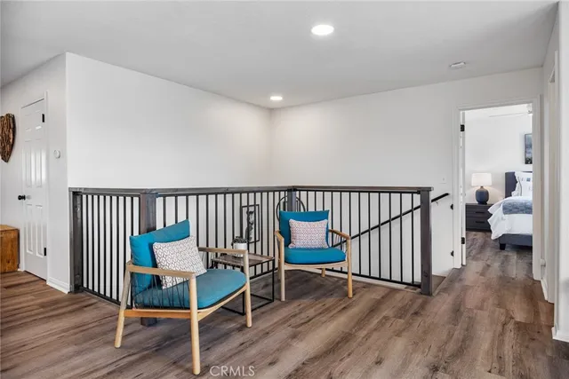 a bedroom with furniture and a wooden floor