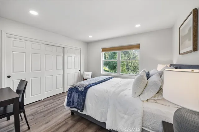 a bedroom with a bed a table and chair