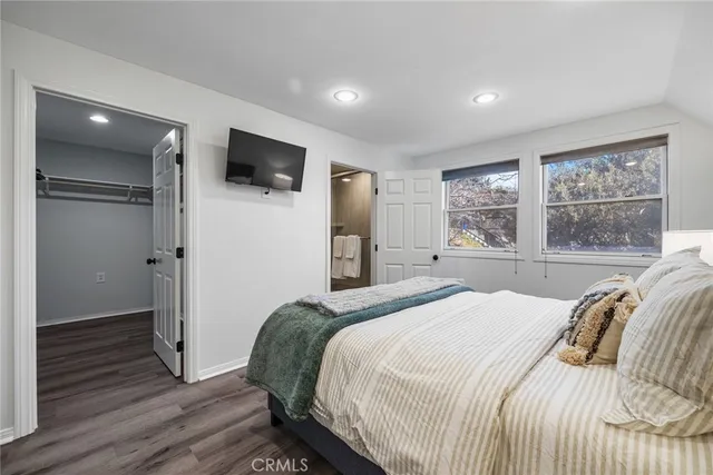 a bedroom with a bed and a flat screen tv