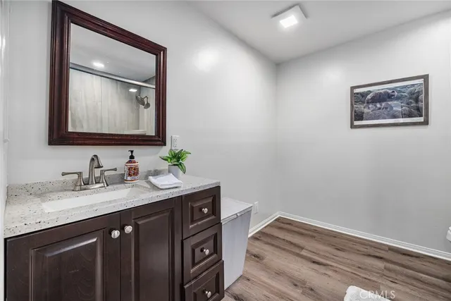 a bathroom with a granite countertop sink mirror and vanity