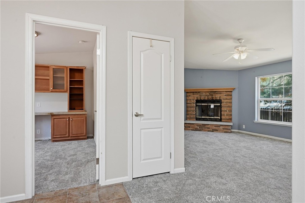 2860 Spring Valley Road Clearlake Oaks, CA 95423 - Photo 9 of 38 an empty room with windows cabinet and a fireplace