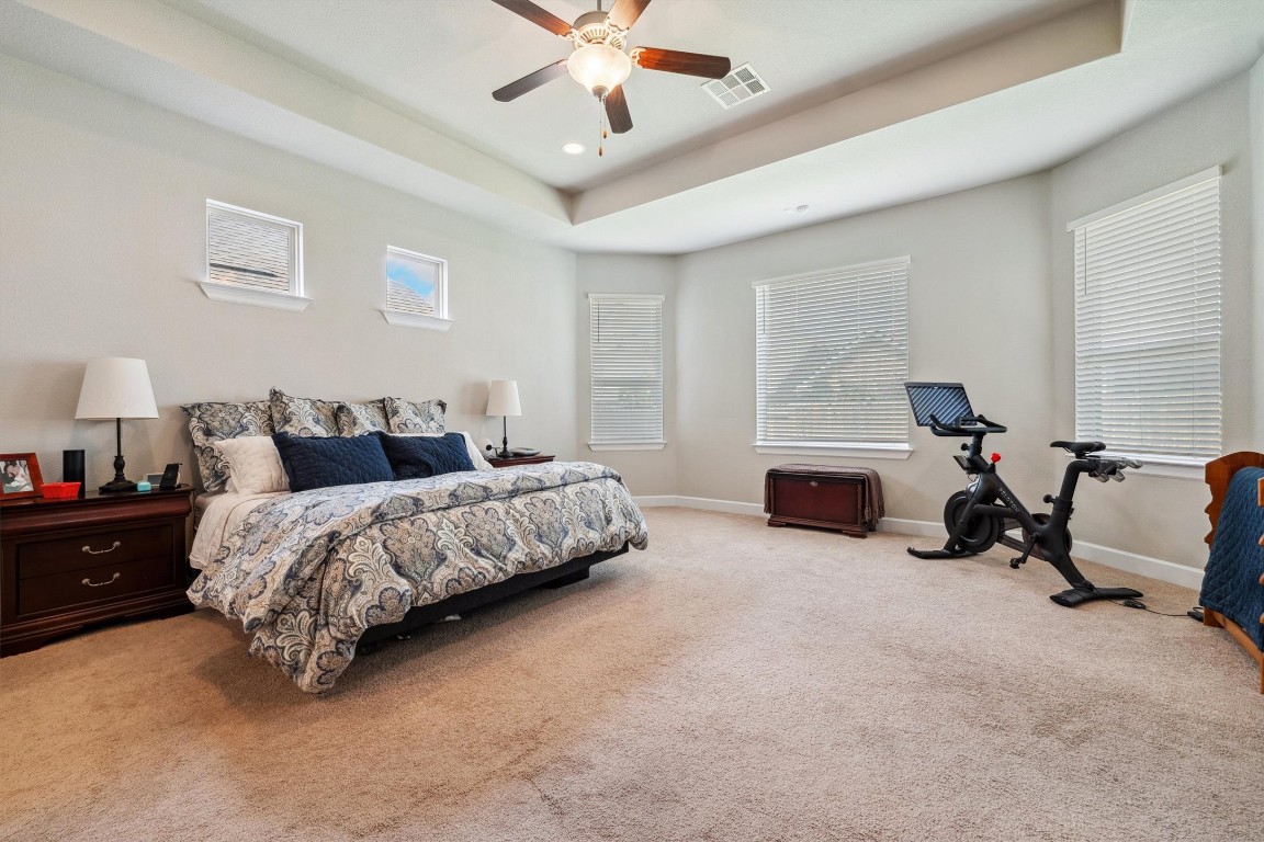 1005 Hezekiah Lane Leander, TX 78641 - Photo 18 of 36 a spacious bedroom with a bed and a couch