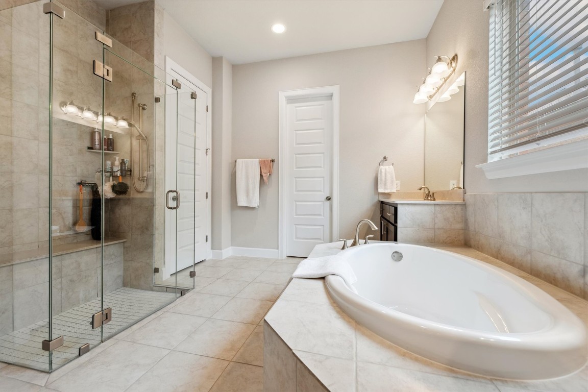1005 Hezekiah Lane Leander, TX 78641 - Photo 21 of 36 a bath tub sitting next to a bathroom