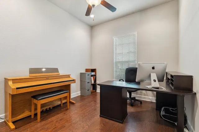 a view of a workspace with furniture and a window