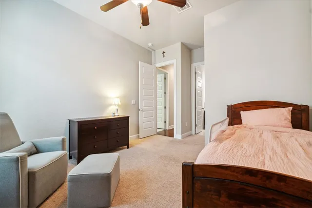 a bedroom with a bed and a ceiling fan