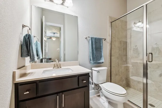 a bathroom with a sink toilet and shower