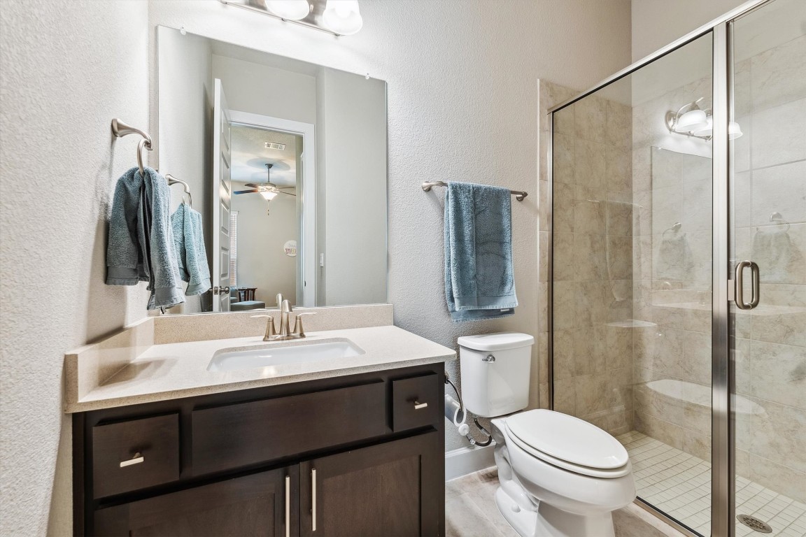 1005 Hezekiah Lane Leander, TX 78641 - Photo 27 of 36 a bathroom with a sink toilet and shower