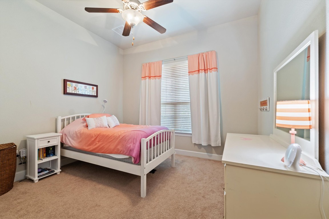 1005 Hezekiah Lane Leander, TX 78641 - Photo 28 of 36 a bed room with a bed and a chandelier