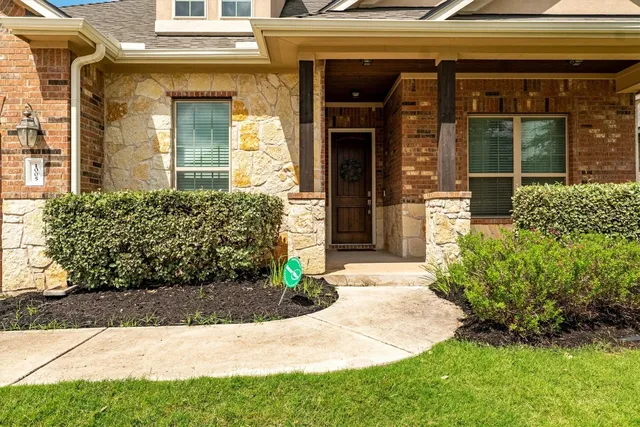 a view of a house with potted plants