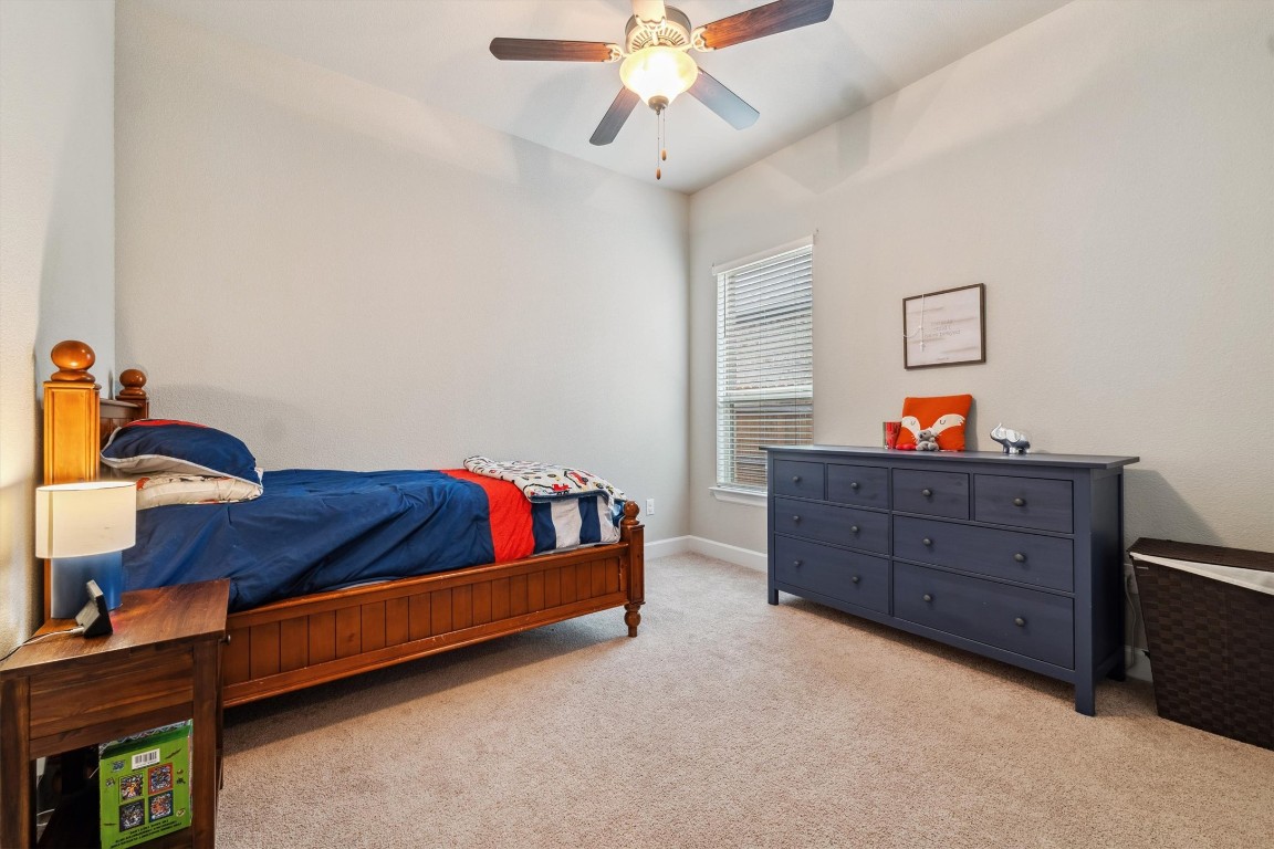 1005 Hezekiah Lane Leander, TX 78641 - Photo 32 of 36 a bedroom with a bed and a dresser in it
