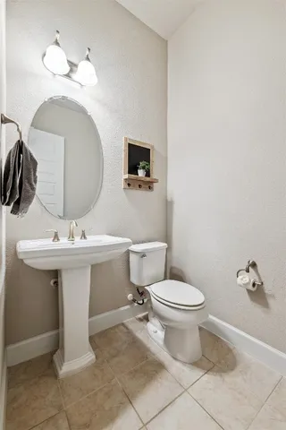 a bathroom with a sink toilet and a mirror