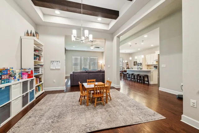 a dining room with furniture and wooden floor